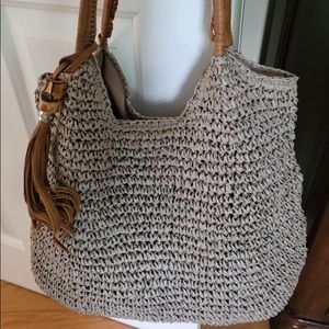 Grey knitted purse with a brown handle